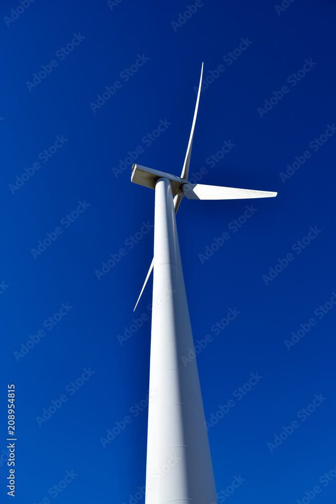 Views from below of wind shovels moving to the rhythm of the wind. Photograph taken in a wind park in Segovia (Spain) Views from below of wind shovels moving to the rhythm of the wind. Photograph taken in a wind park in Segovia (Spain)