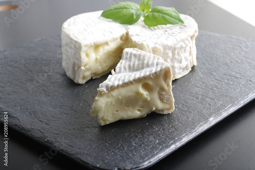 Camembert brie cheese on a stone background