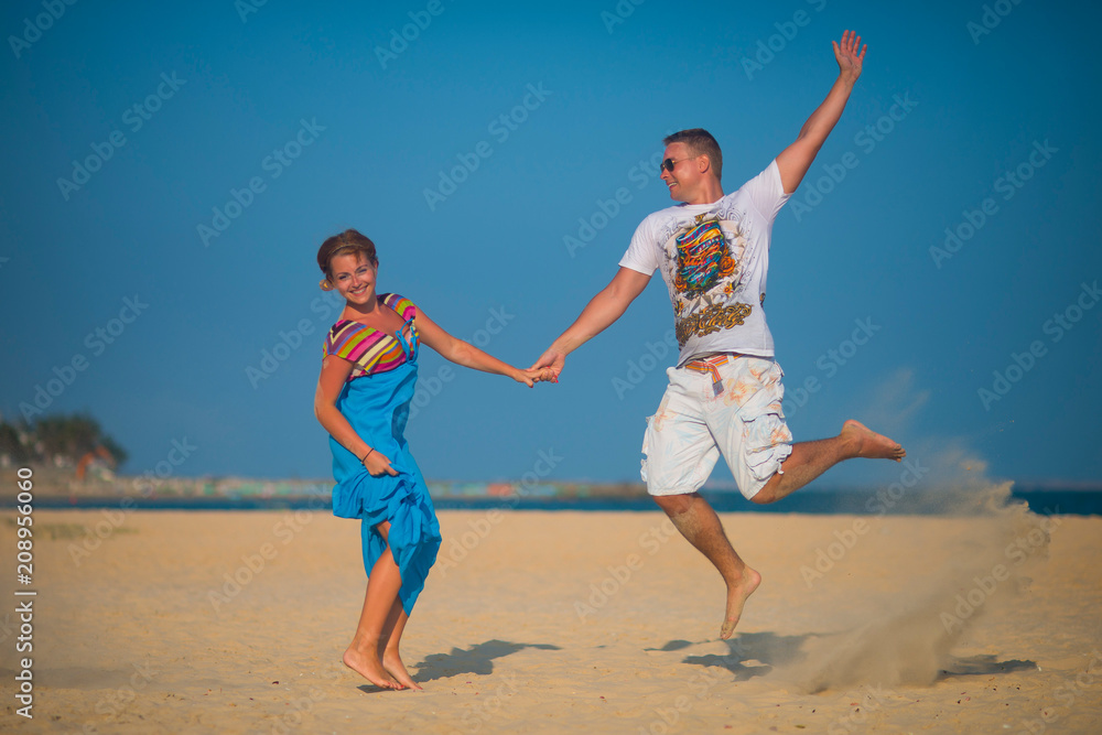 Man and woman jumped on the beach Man and woman jumped on the beach