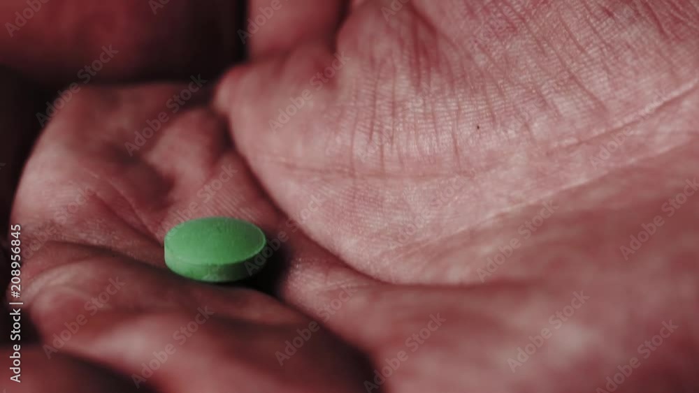 Pill falling in an open palm. Multiple takes. Pill falling in an open palm. Multiple takes.