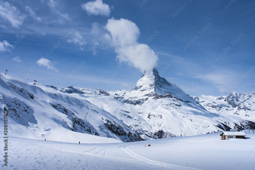 The famous mountain Matterhorn peak with cloudy and blue sky from Gornergrat, Zermatt, Switzerland