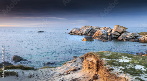 Sunset coastline with sand and stones in Brittany, France