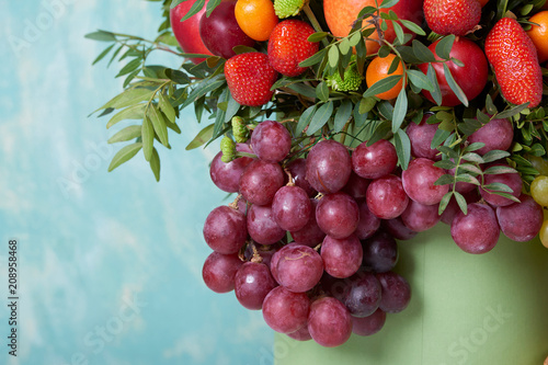 a beautiful bouquet of fruits and flowers for the birthday of strawberries grape peaches