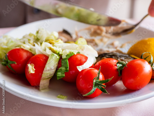 Healthy dinner - plate full of stewed vegetables and grilled tomatoes.