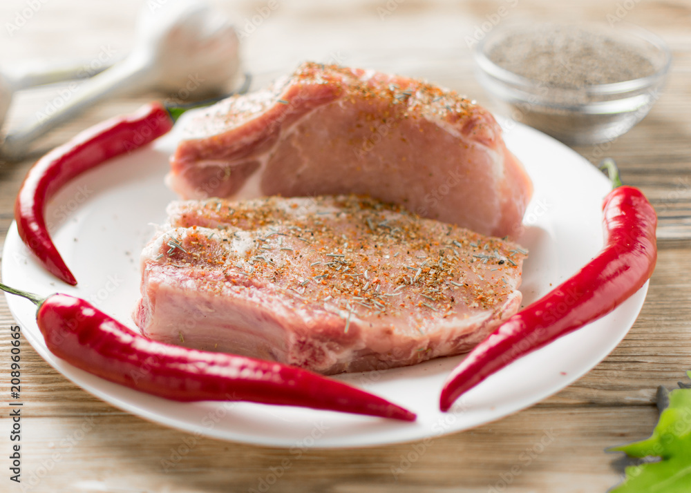 Raw pork ribs with hot red pepper. Preparation of meat for grilling. Raw pork ribs with hot red pepper. Preparation of meat for grilling.