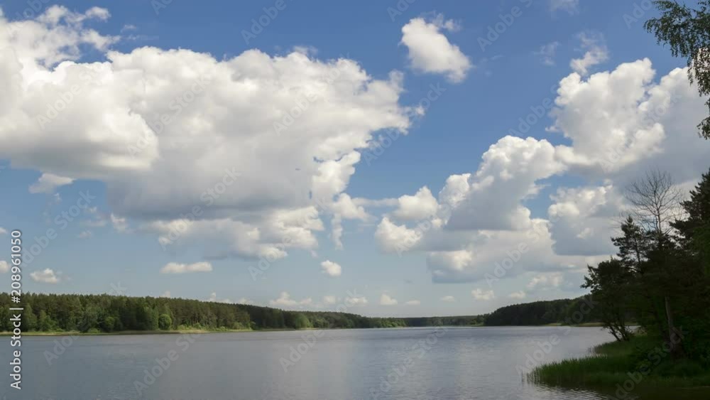 Cumulus cloud over the lake, time-lapse 4K. The movement of clouds over a summer lake.
Cumulus cloud over the lake, time-lapse 4K. The movement of clouds over a summer lake.