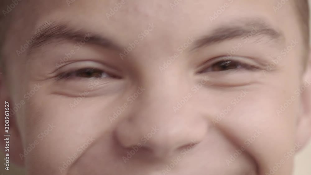 Close up portrait of teen boy looking at camera. Macro of beautiful face teenager with brown eyes. Close up portrait of teen boy looking at camera. Macro of beautiful face teenager with brown eyes.
