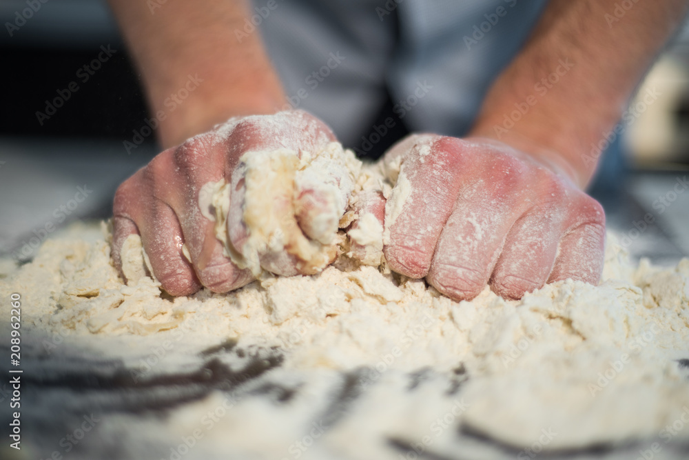 a man prepares the dough