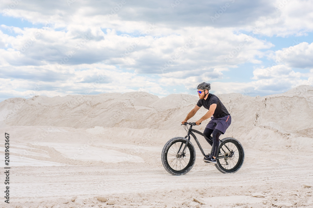  Training a bicyclist in a chalky quarry. A brutal man on a fat bike.