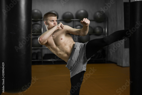 kickboxer beats a Boxing bag © Vladimir