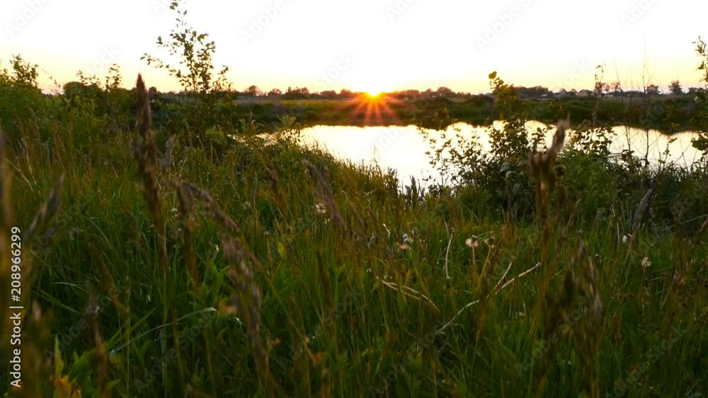Beautiful sunset by the lake. The camera rises to the sky. Slow motion Beautiful sunset by the lake. The camera rises to the sky. Slow motion
