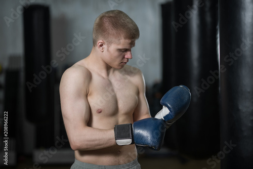 boxer puts on Boxing gloves