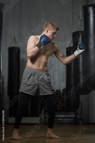 Young boxer training with punching bag © Vladimir