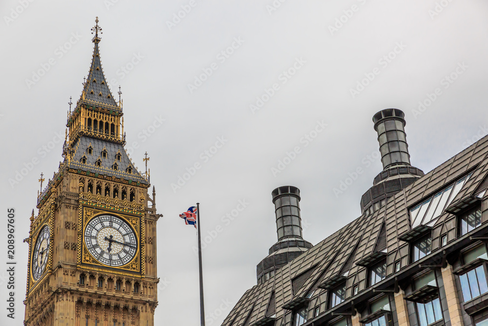 High part of the Big Ben Clock Tower in a cloudy day. London, England