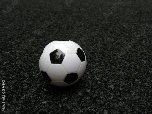 Football ball at the stadium with a black soft rubber coating