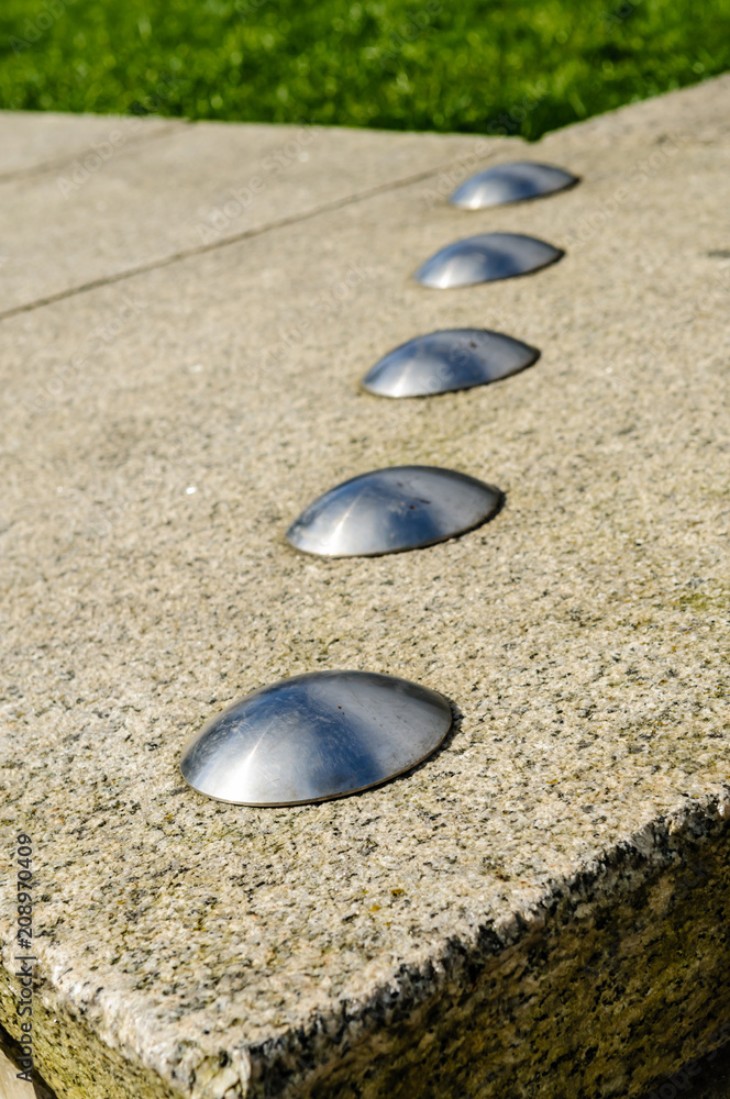 Obraz premium Anti-skateboarding devices installed on a low stone wall