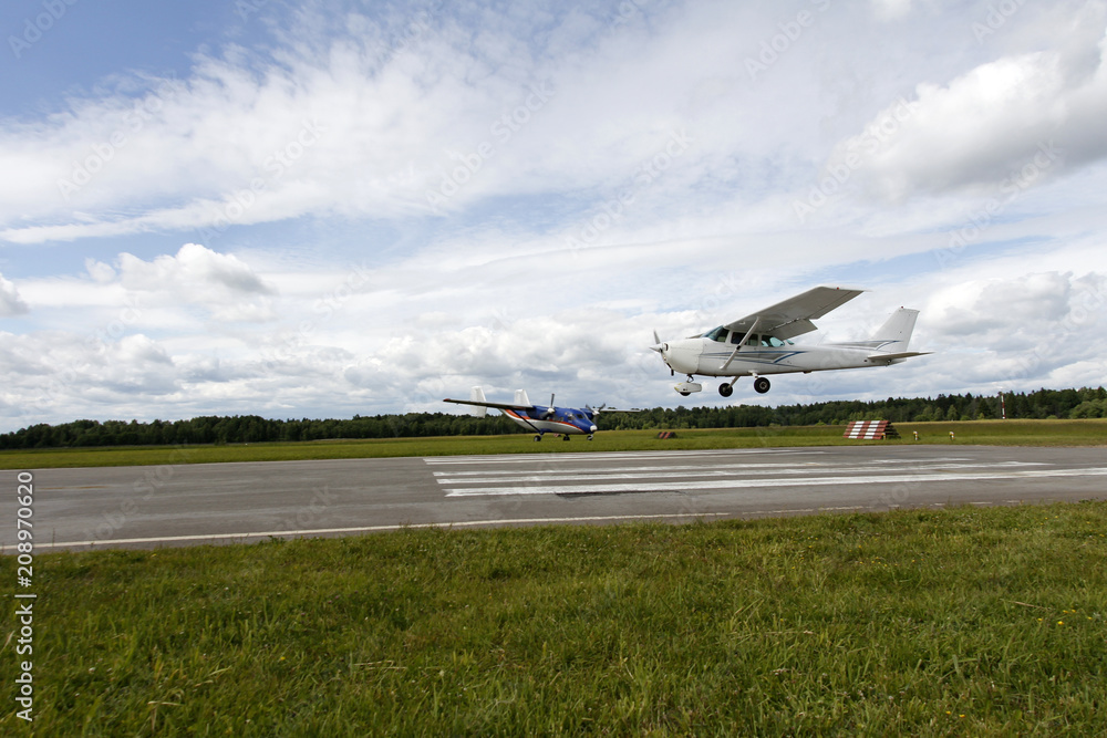 Fototapeta premium Small white airplane is landing