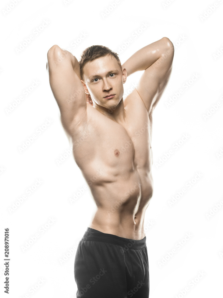 beautiful bodybuilder shows off his muscles on white background