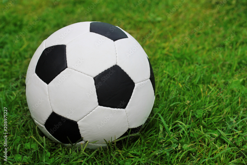 soccer ball on the field with green grass. Copy space.