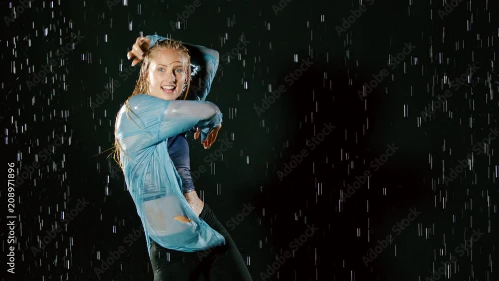 Beautiful blond woman hip-hop dancing in the rain. Slow Motion. Beautiful blond woman hip-hop dancing in the rain. Slow Motion.