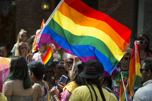 Participants wave rainbow flag and celebrate in the annual Pride Parade as it passes through Greenwich Village.