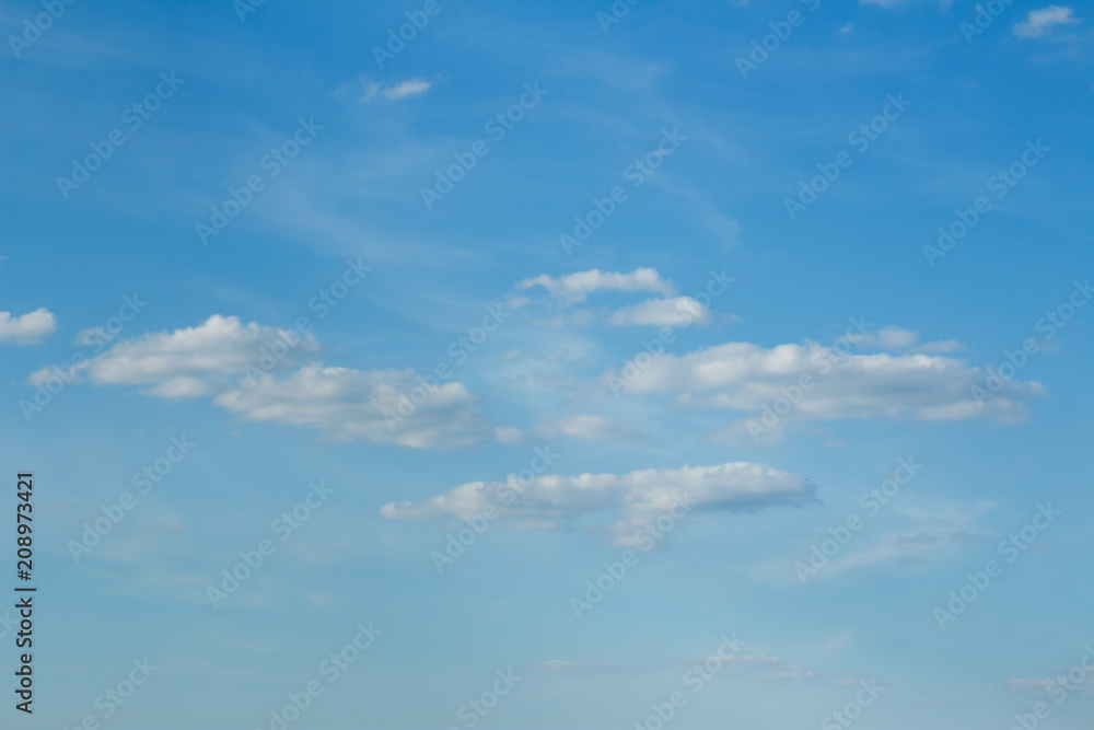 Light snowy white fluffy Clouds on a background of a gentle blue sky