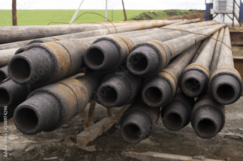 Oil drill pipe. Laid out drilling pipes at a well site.Well Drilling.Drill Pipe Stacked on Pipe Deck. Oil drill pipe. Laid out drilling pipes at a well site.Well Drilling.Drill Pipe Stacked