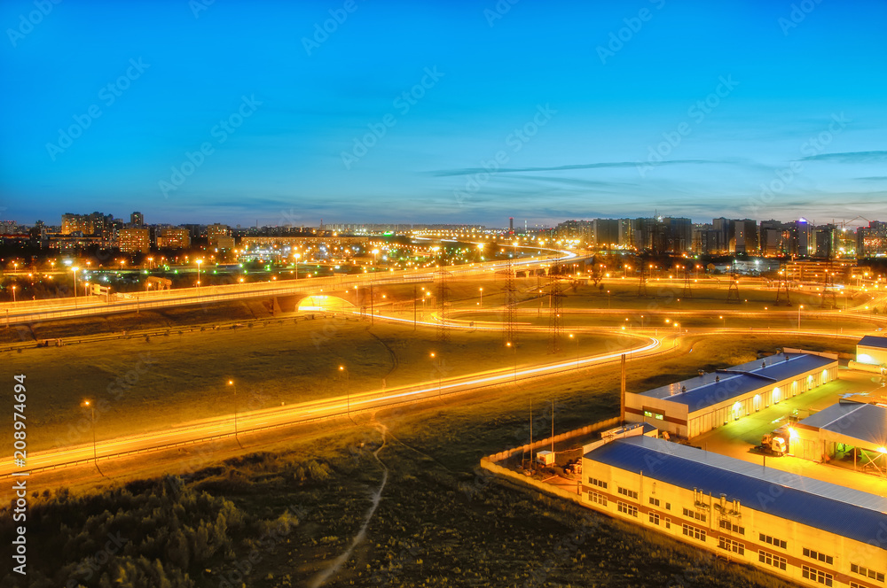 ring road in St. Petersburg at white night, new buildings and high-voltage power lines