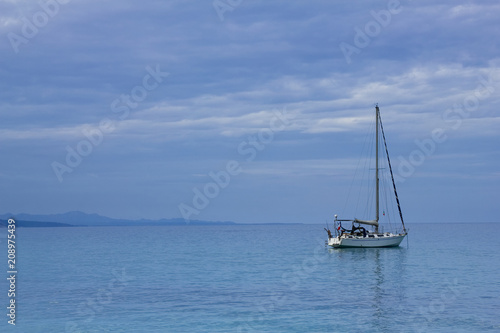 Lonely sailboat on the mediterranean sea at Sardegna coastline © encierro