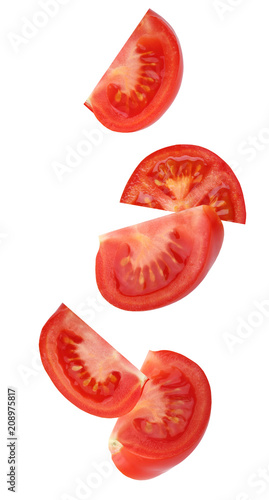 Falling (flying) tomato, isolated on white background.