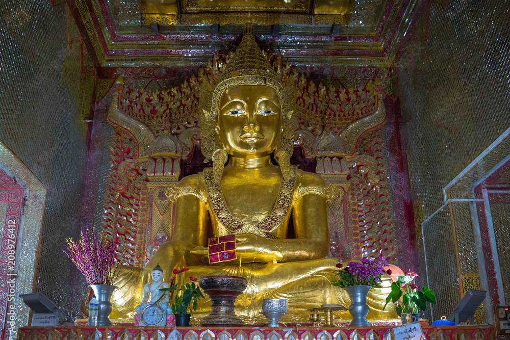 Mandalay, Myanmar, November 2017 - view of a golden budhha statue in a shrine at Mandalay Hill