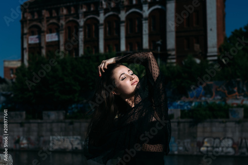 portrait of a beautiful girl on the street on the bridge near the river. sexuality