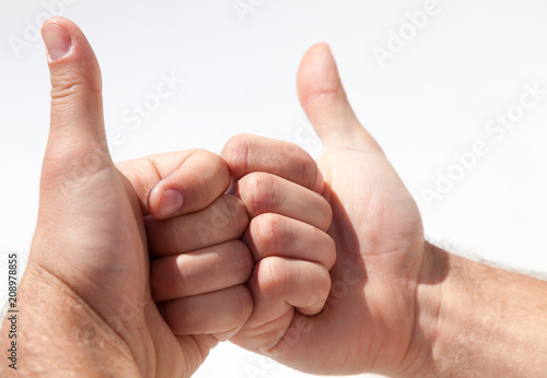 Raised thumbs isolated on a white background. Symbol of success