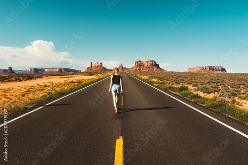 Young woman on the road over monument valley, USA © Klara