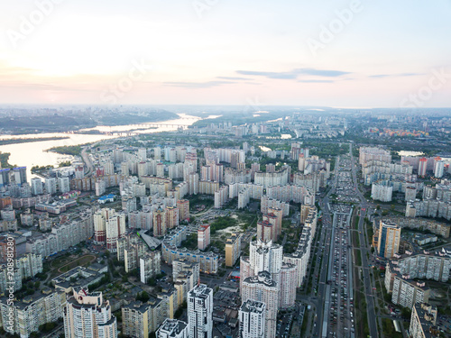 A bird s eye view  aerial panoramic view from drone to the Darnyts kyi district of Kiev  Ukraine and view to the right bank of Dnieper at sunset in the summer.