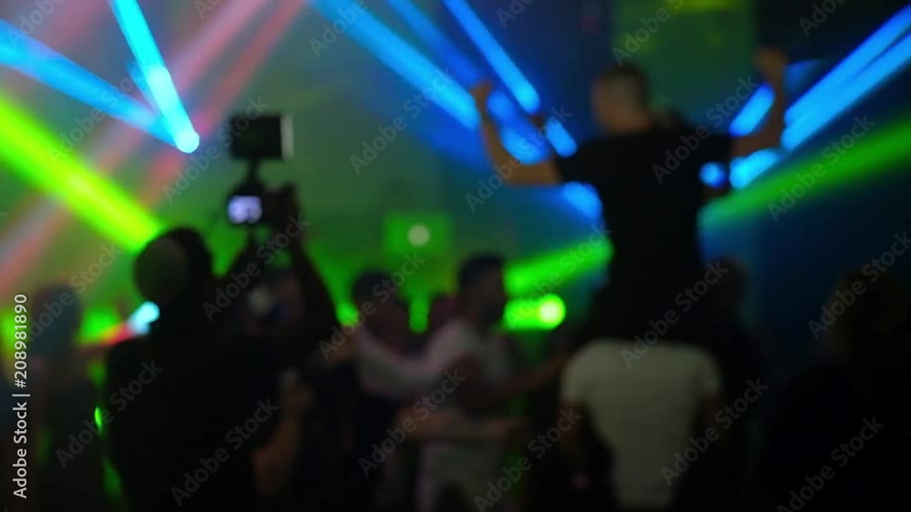 Dancing people out of focus.Laser show HD video Dancing people out of focus.Laser show HD video