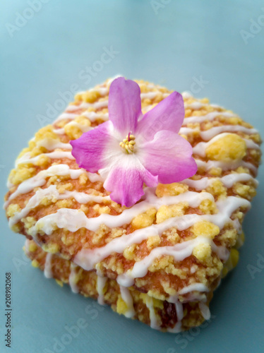 Tasty glazed dessert with a flower on top.