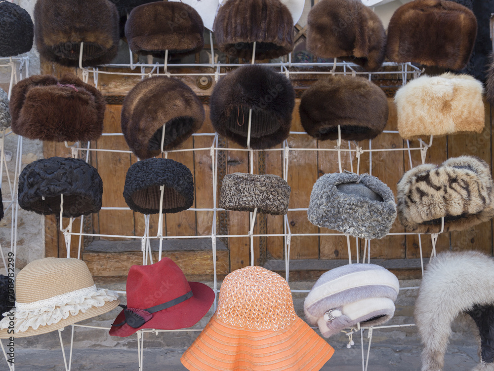 Natural fur hats. Handmade wool fur headdress shop bazaar in Bukhara,  Uzbekistan. Selling group of different winter fur hats for women and men.  Stock Photo | Adobe Stock