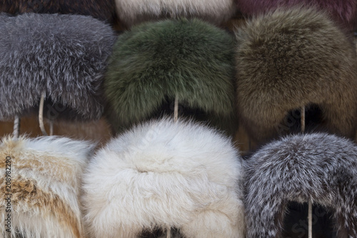 Natural fur hats. Handmade wool fur headdress shop bazaar in Bukhara, Uzbekistan. Selling group of different winter fur hats for women and men.