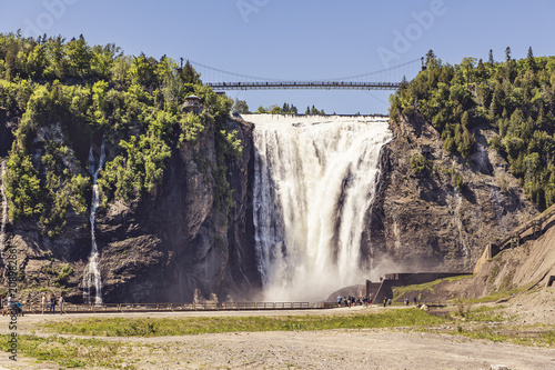 blue lake and powerful waterfall Montmorency in Montmorency Falls Park, in Quebec