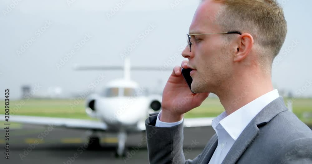 Businessman talking on mobile phone at terminal 4k Businessman talking on mobile phone at terminal 4k