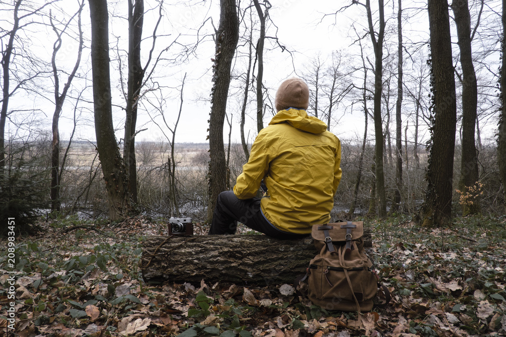 Fototapeta premium Man with backpack in wild forest. Travel and adventure concept. Landscape photography