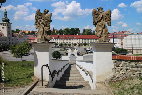 Steps from Most Holy Trinity church to Komenskeho square with town hall (left) in Fulnek, Czech republic