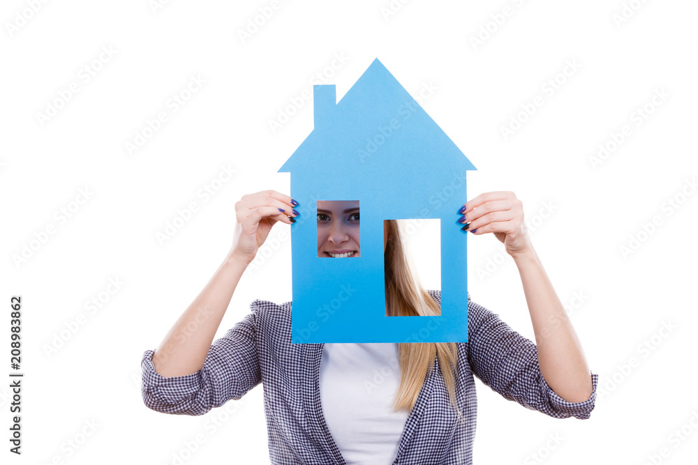 Happy woman holding blue paper house Happy woman holding blue paper house