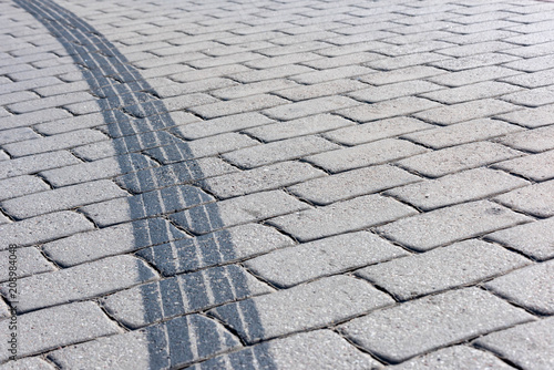 Tracks from the motorcycle tire on the pedestrian sidewalk