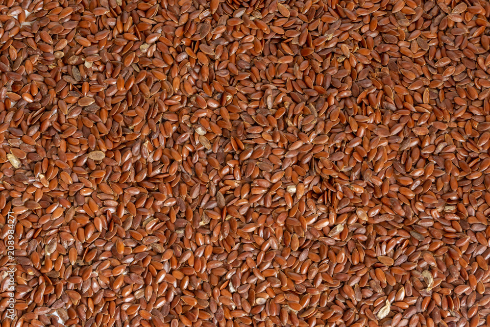 Many raw flax seeds, wholesome ingredient used in cooking. Many raw flax seeds, wholesome ingredient used in cooking.