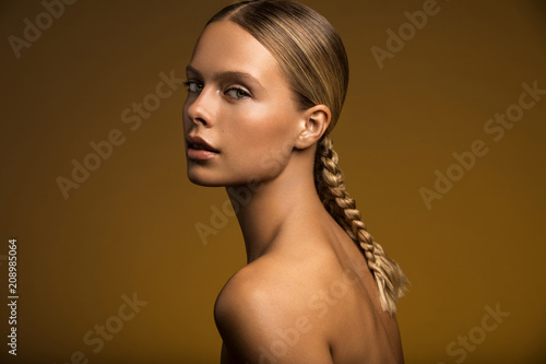 Woman with braid looking at camera