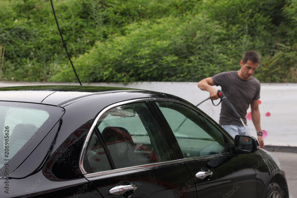 Man washing car outdoors Man washing car outdoors