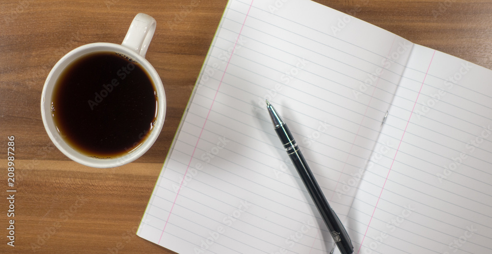 Planning - Blank paper with pen and cup of tea on wood background Planning - Blank paper with pen and cup of tea on wood background