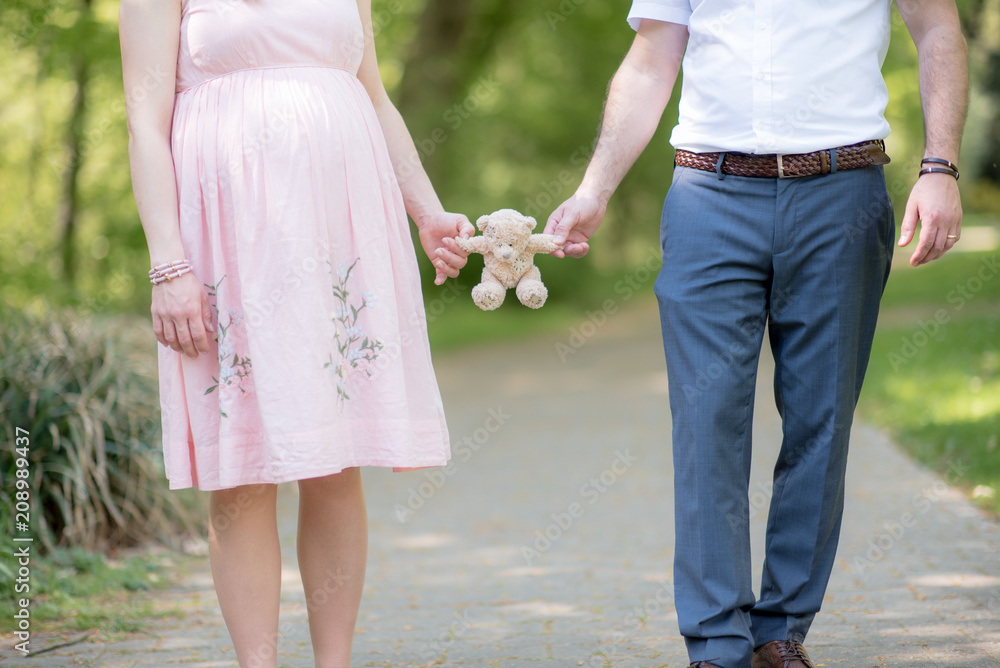 Happy and young pregnant couple hugging in nature - Detail of young pregnant couple - New Family Happy and young pregnant couple hugging in nature - Detail of young pregnant couple - New Family